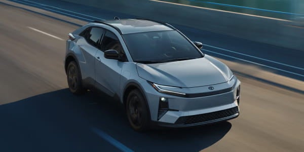 Silver Toyota C-HR driving on a road, shown from an elevated front three-quarter view.